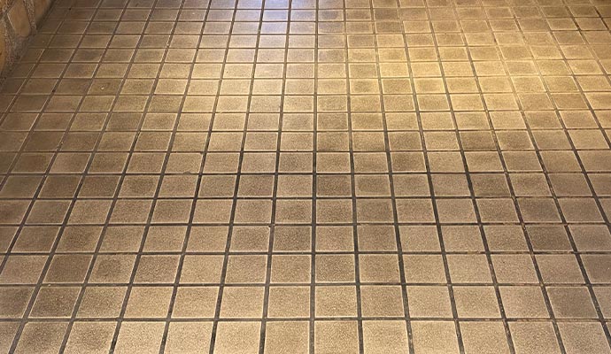Close-up view of dirt and stains on tile and grout